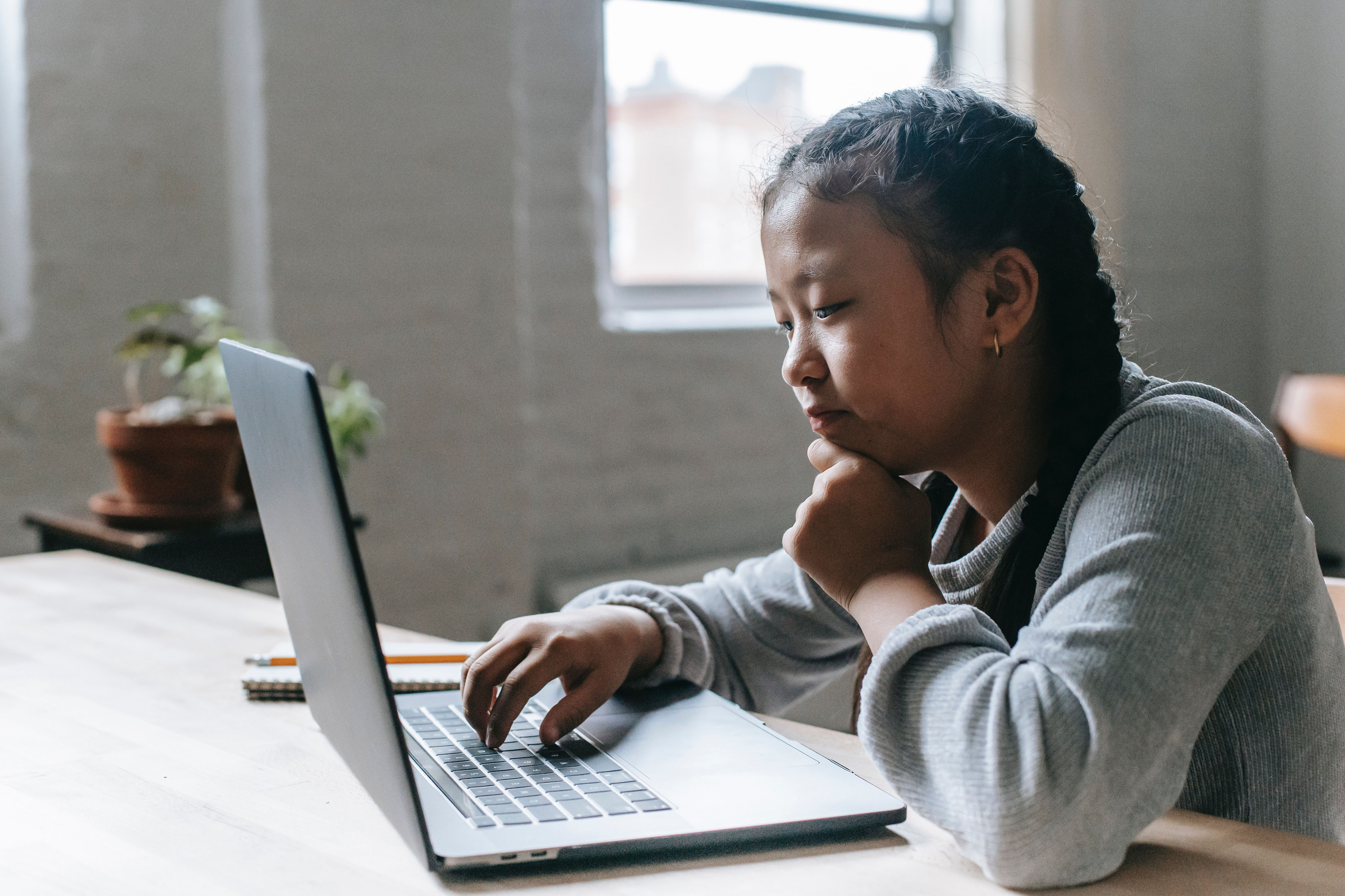 Young girl pondering a computer screen